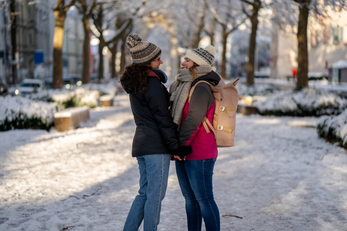 Young female couple embracing in winter in Konstanz, Bodensee