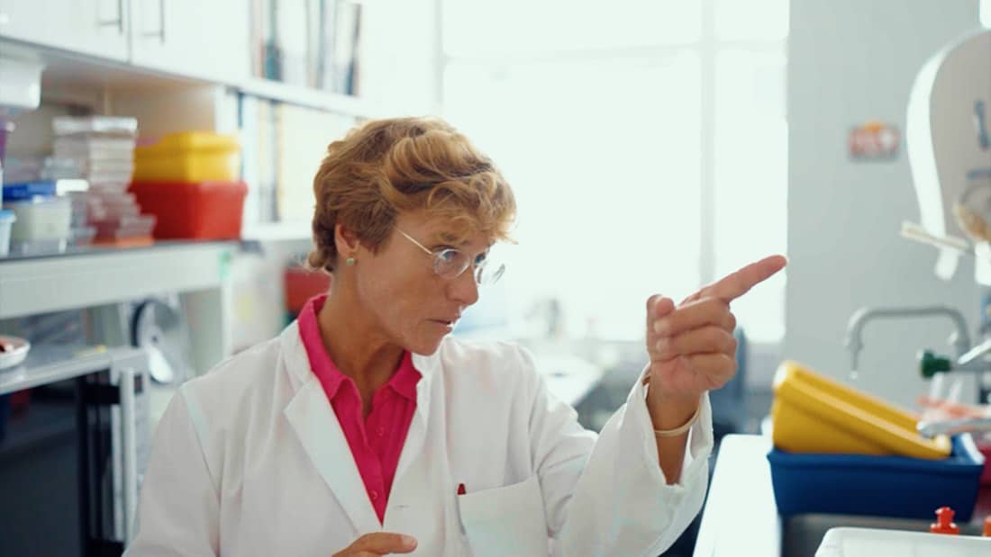 Female scientist pointing to a board in a laboratory
